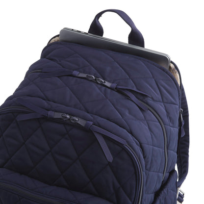 Navy blue quilted backpack with a laptop compartment on a white background